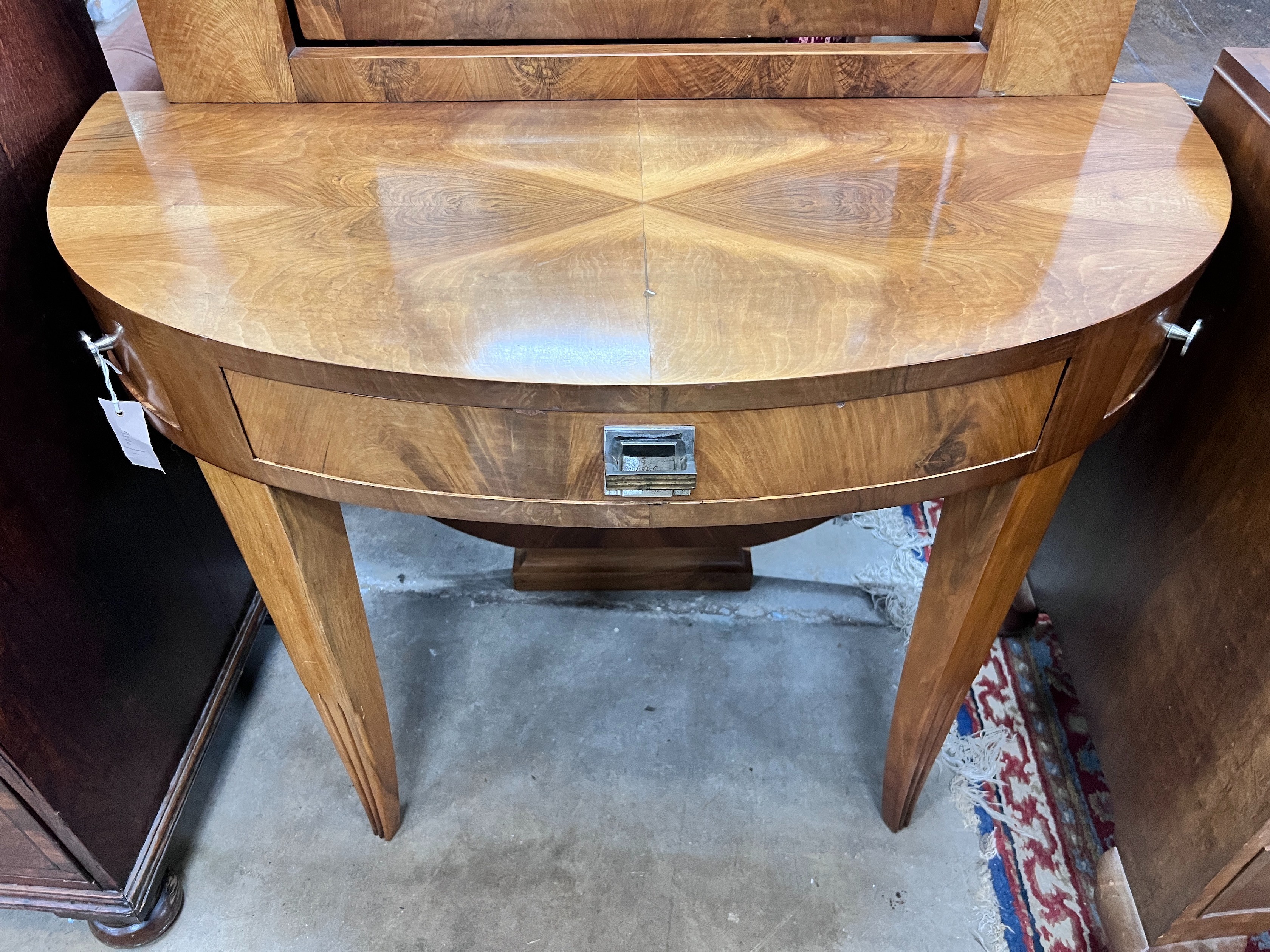 An Art Deco walnut D shaped dressing table, width 100cm, depth 45cm, height 122cm *Please note the sale commences at 9am.
